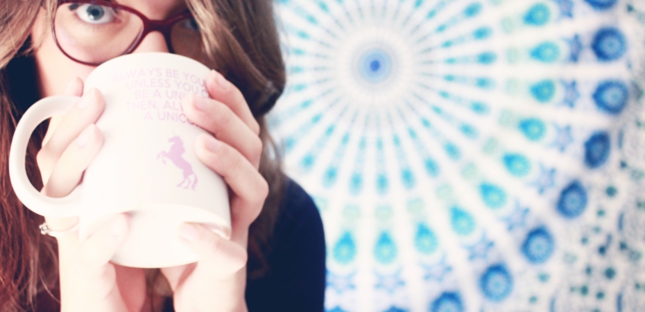 Blogger with cup that reads: Alway be yourself, unless you can be a unicorn, then always be a unicorn